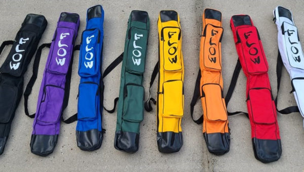 a rainbow of staff bags all displayed in a group